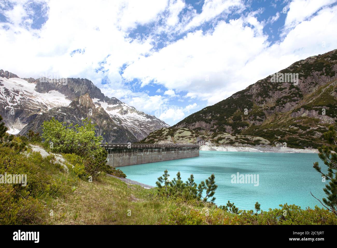 Alps mountains beautiful landscape with turquoise water lake. High mountains nature and view on dam of Gelmer lake reservoir, sunny summer day. Stock Photo