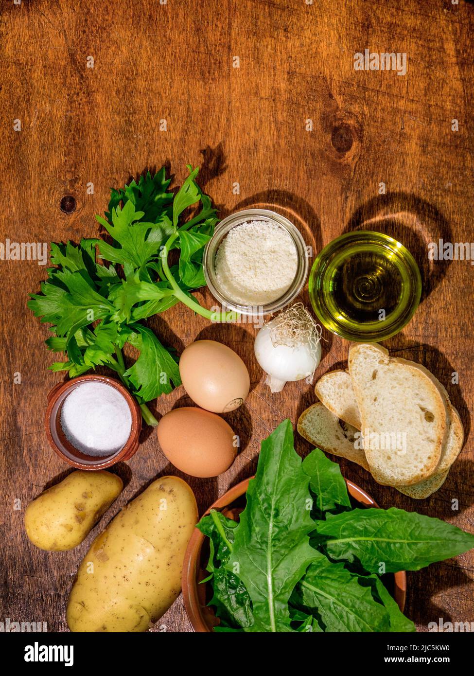 ingredients for the 'acquacotta' recipe, peasant soup made with various vegetables, eggs, pecorino cheese, onion, celery, stale bread, oil, salt Stock Photo