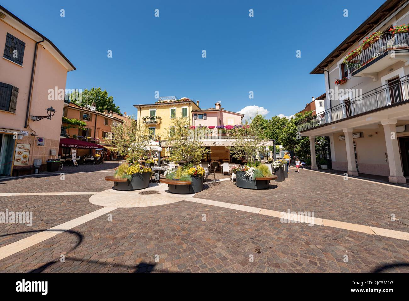 Small square in Bardolino village with restaurants and bars. Tourist resort on the coast of Lake Garda (Lago di Garda). Verona province, Veneto, Italy Stock Photo