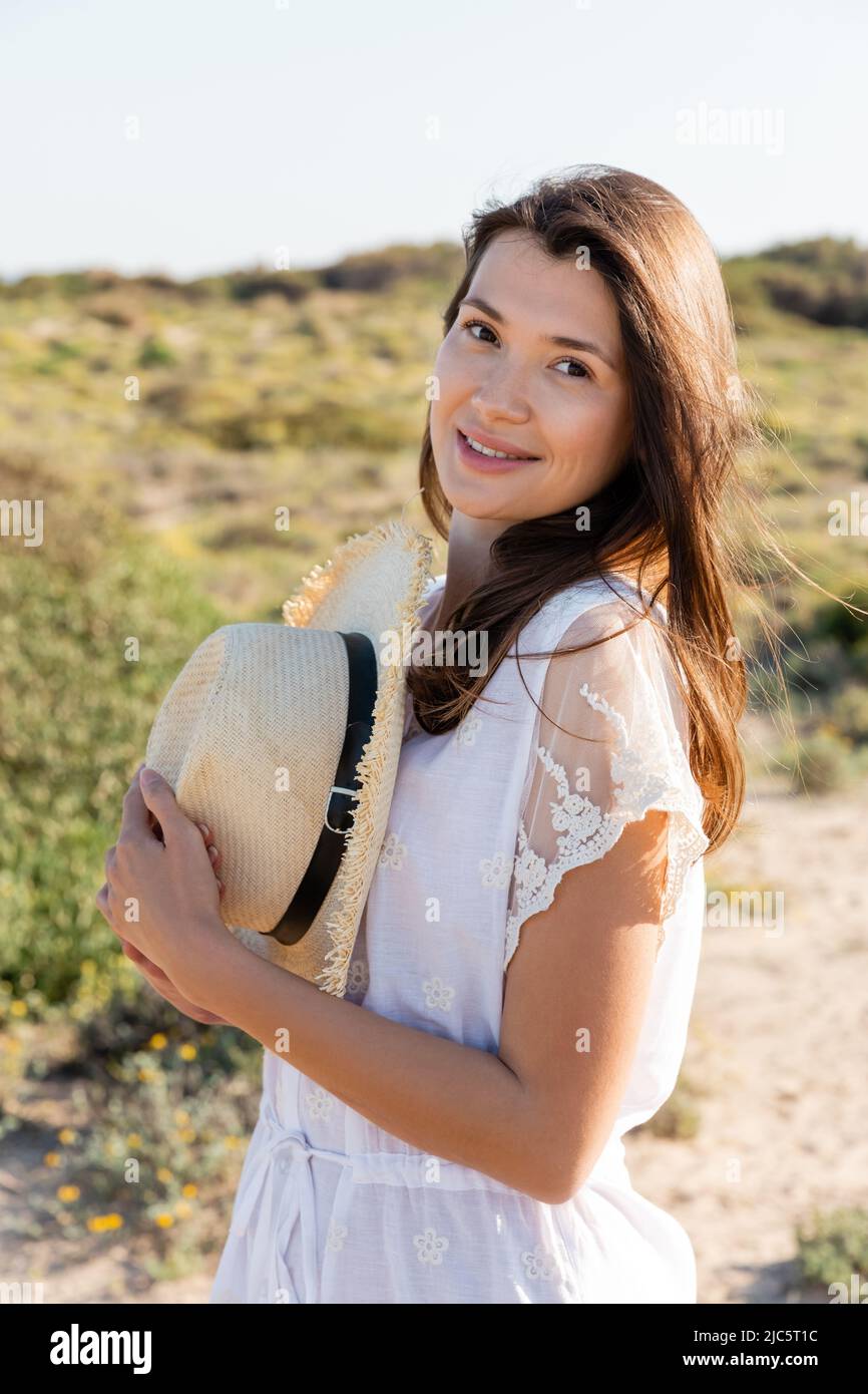Woman holding sun hat hi-res stock photography and images - Alamy