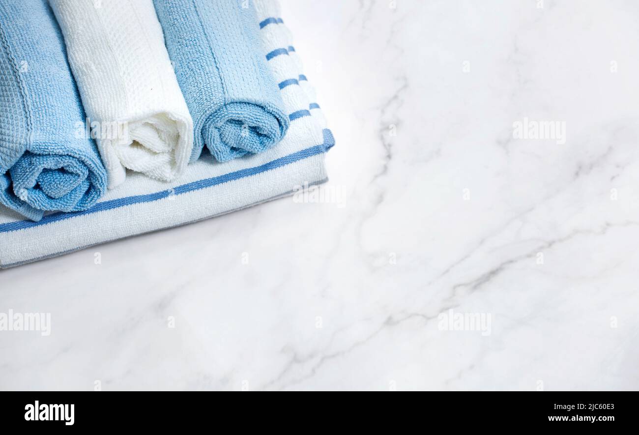 Towels rolled and stacked on bathroom table top view.Shower towel empty