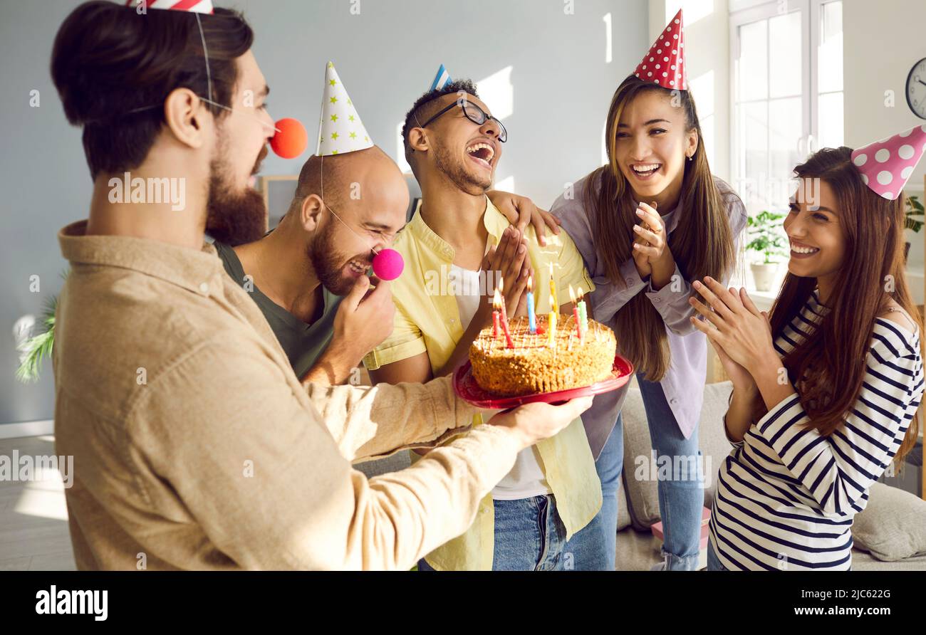 Happy friends greeting girl colleague with birthday Stock Photo
