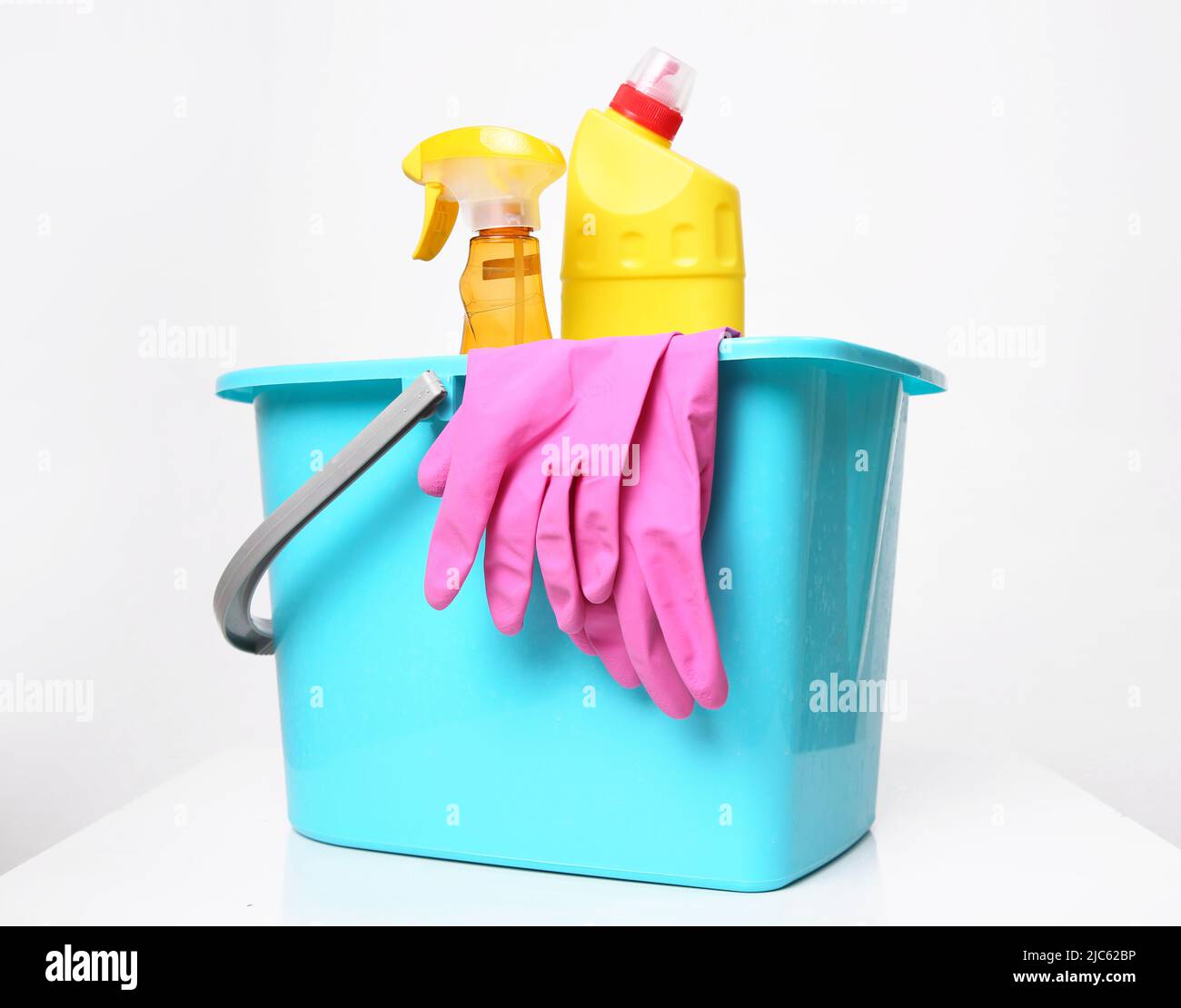 Plastic bucket with desinfctant bottles.Housekeeping objects.Sanitary items.Housework supplies