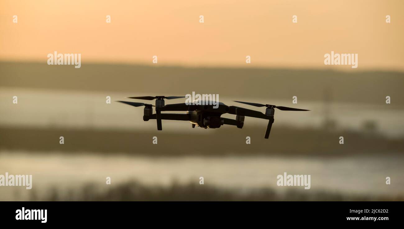 Quadcopter with a camera in flight. Technique for aerial photography