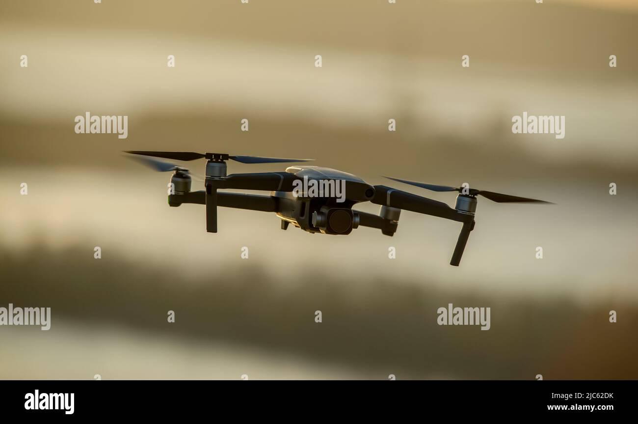 Quadcopter with a camera in flight. Technique for aerial photography