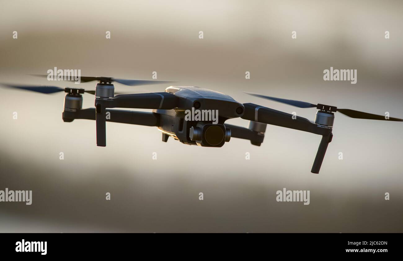 Quadcopter with a camera in flight. Technique for aerial photography