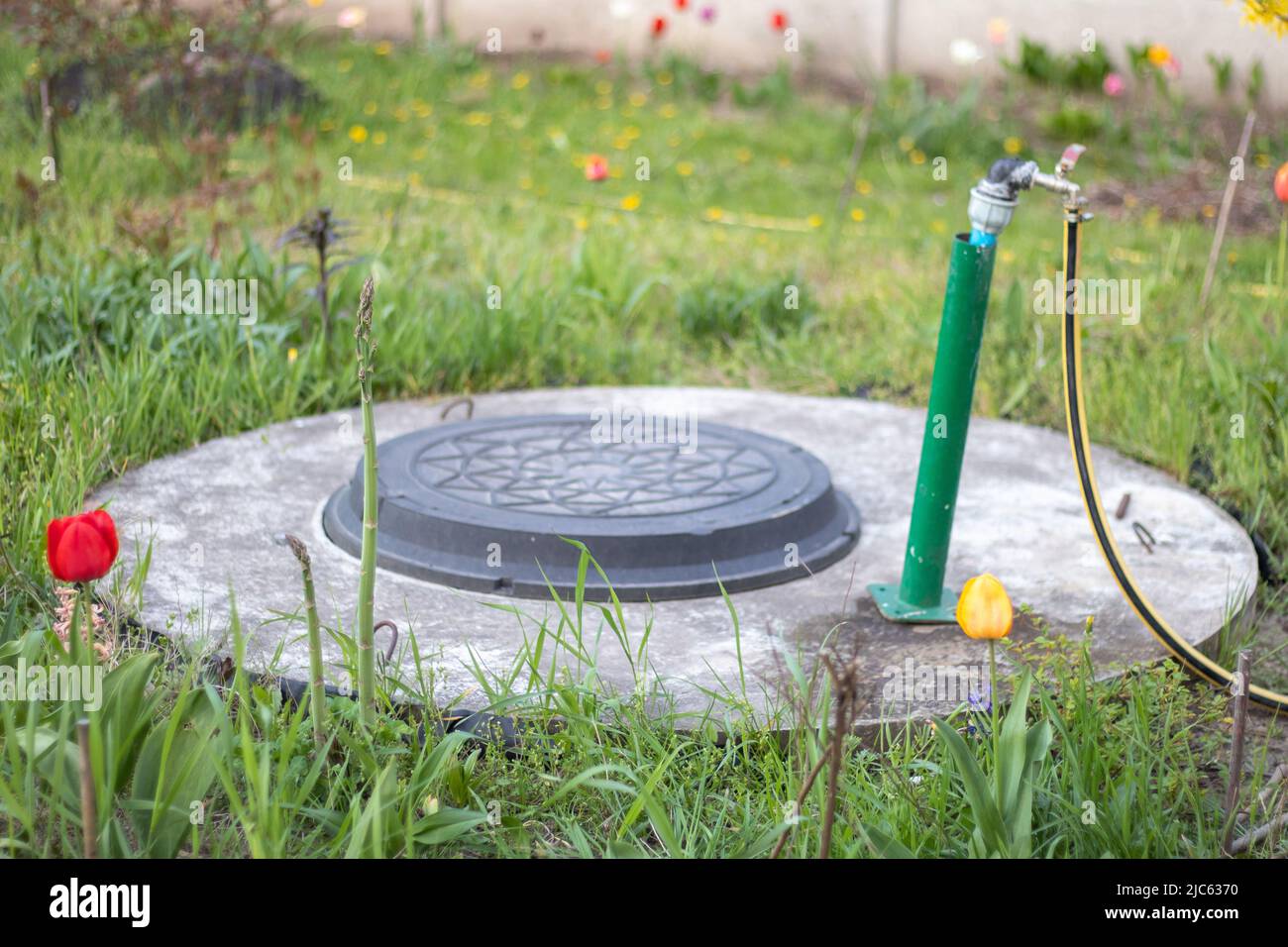 Plumbing, water pump from a well. An outside water faucet with a yellow