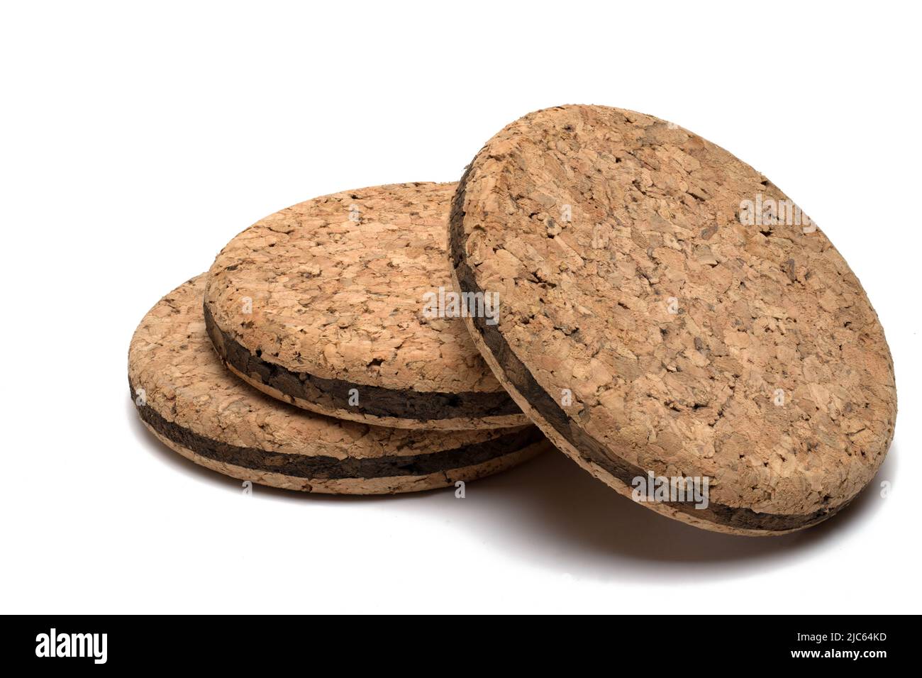 Close up of three round cork coasters stacked on top of each other and