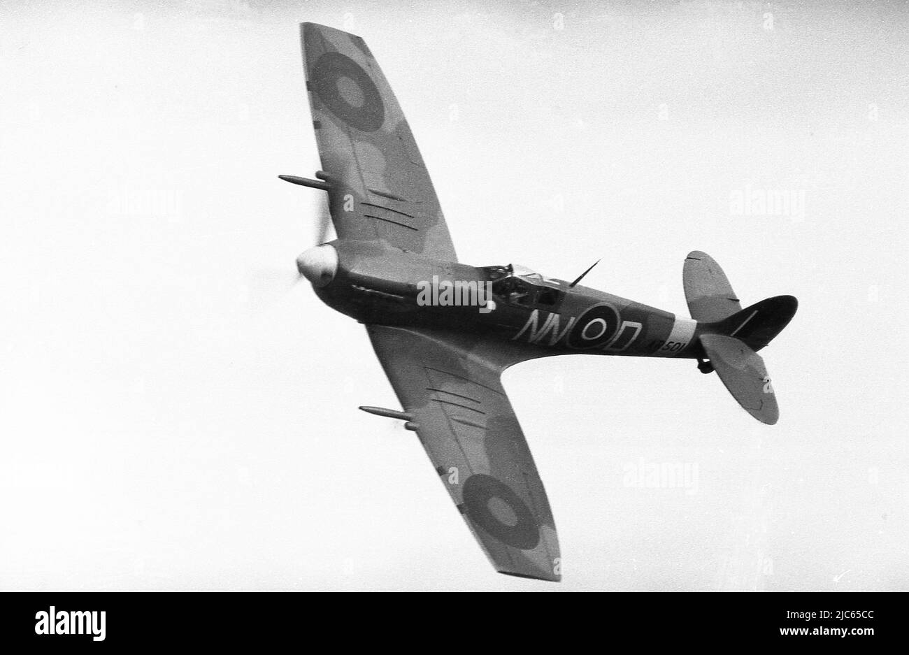 1970, historical, RAF Supermarine Spitfire NN-N in flight in the air over Shuttleworth, England, UK. Built at Castle Bromwich, West Midlands, this Spitfire was sent to the 310 (Czech) Squadron and coded 'NN-N'. No.310 Squadron RAF was a Czechoslavk-manned fighter squadron of the RAF in WW2 and the first to be manned by foreign nationals. The spitfire was transferred to the Czech Air Force in 1945 and currently resides on display at the National Technical Museum. Stock Photo