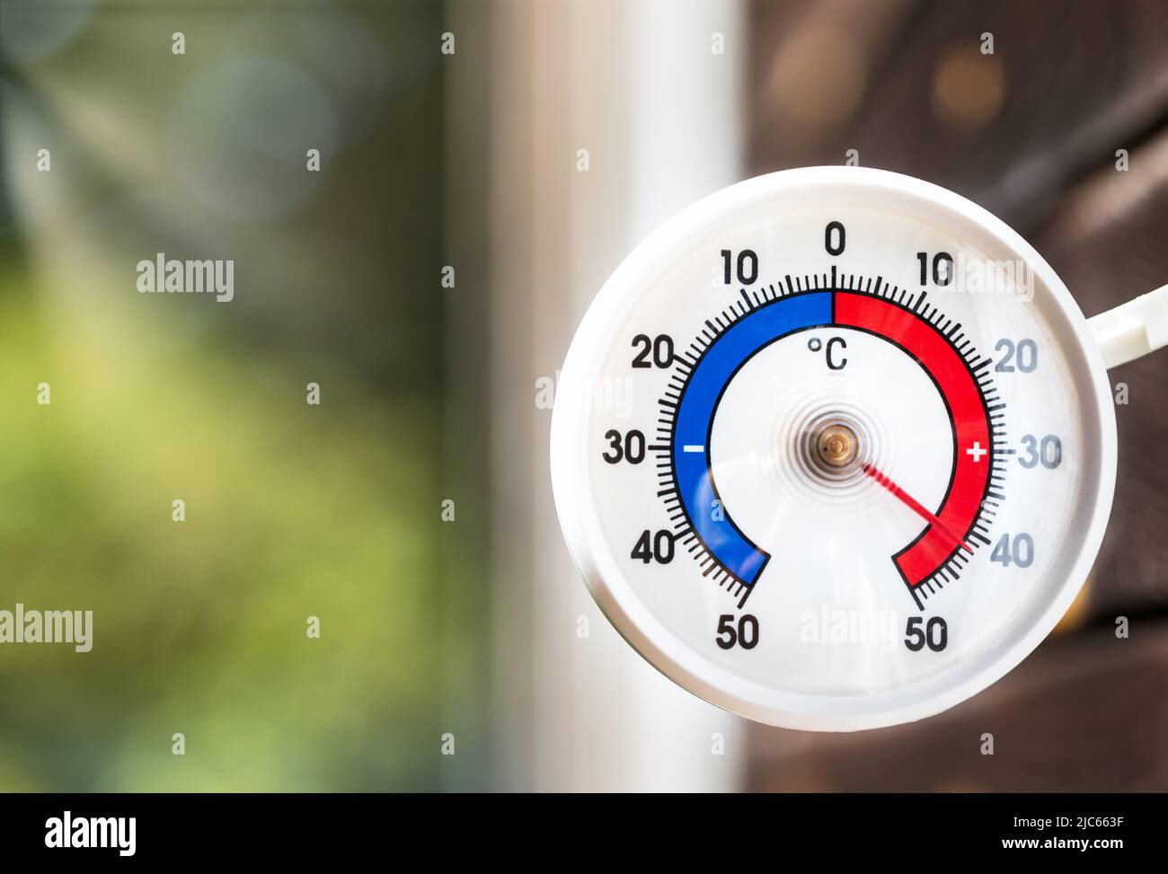 Outdoor thermometer indicating extreme high temperature Stock