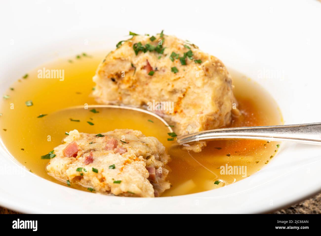 single speckknoedel in soup on wood Stock Photo