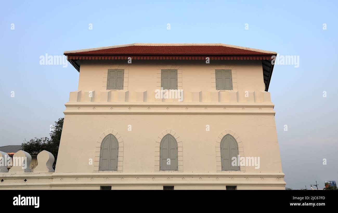 dusty white ancient building facade with beautiful gray wooden windows. Stock Photo