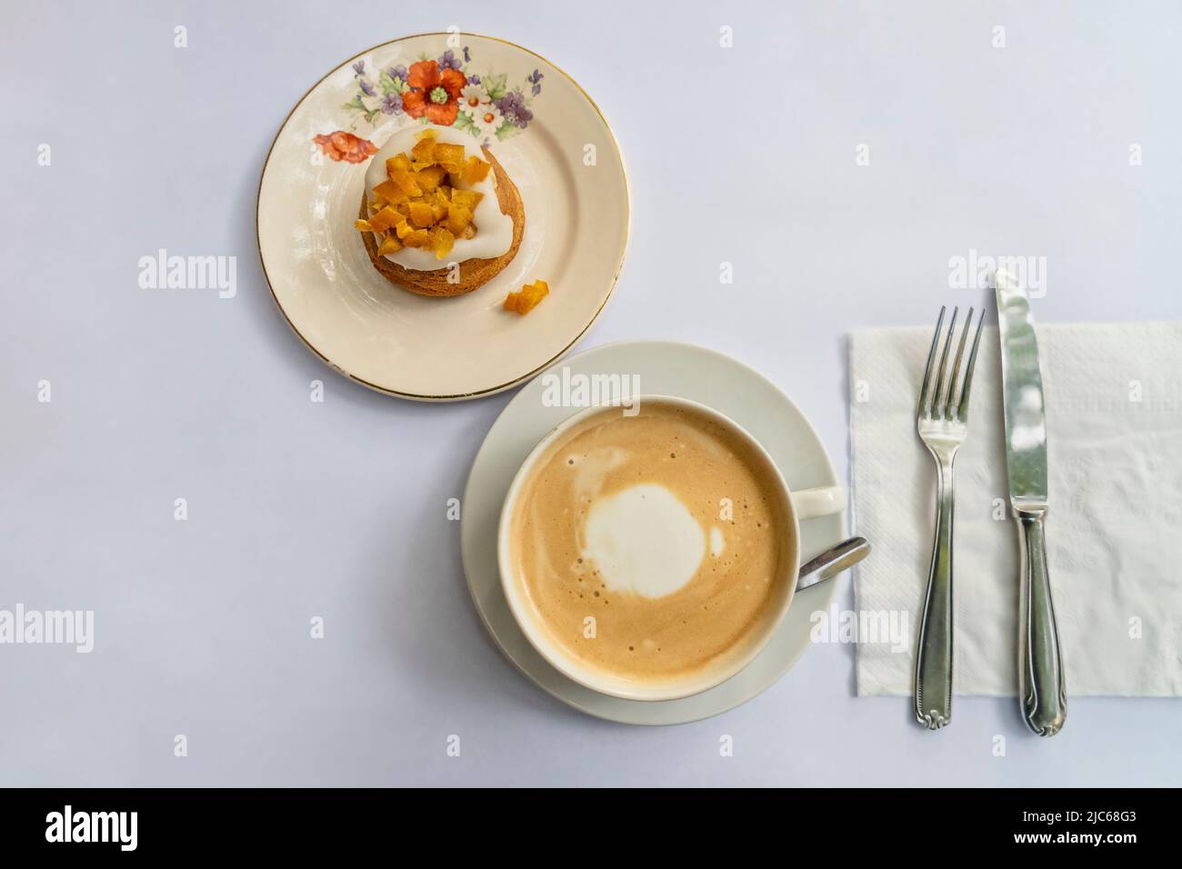 Top view of a latte and an orange cupcake on vintage crockery Stock Photo
