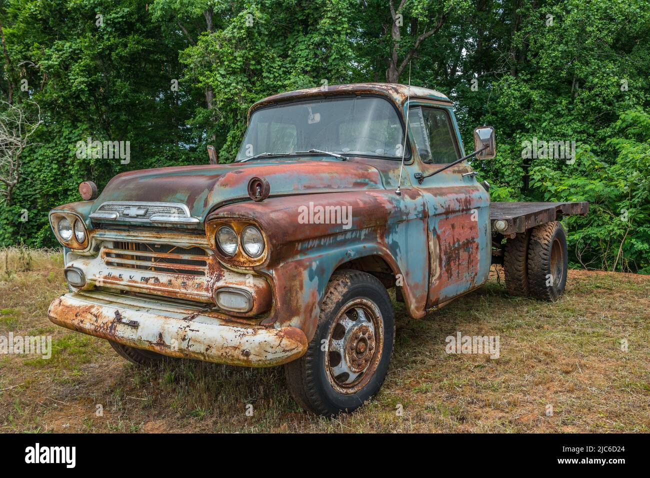 A late model 1950's Chevrolet Apache work truck with a flat-bed on the back still in running condition rusty and lots of patina used on the farm parke Stock Photo