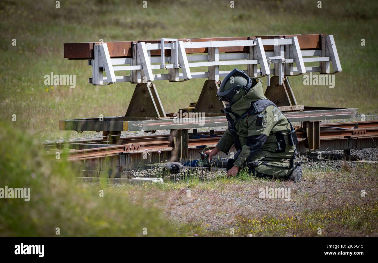 Ravlunda, Sweden. 10th June, 2022. RAVLUNDA 2022-06-10Personnel in bomb protection suit from Norwegian Minedykker Kommandoen when, with the help of bomb robots and water charges, a grenade mounted on railway rails in the training area is disarmed at Friday's press demonstration at the Baltops exercise at Ravlunda firing range on the east coast of Skåne. Over the next few days, 250 participants from eight countries will gather at Ravlunda to practice mine clearance, detection and disarmament of bombs and explosives. About 30 exercise mines have been placed in the sea outside the firing range. T Stock Photo