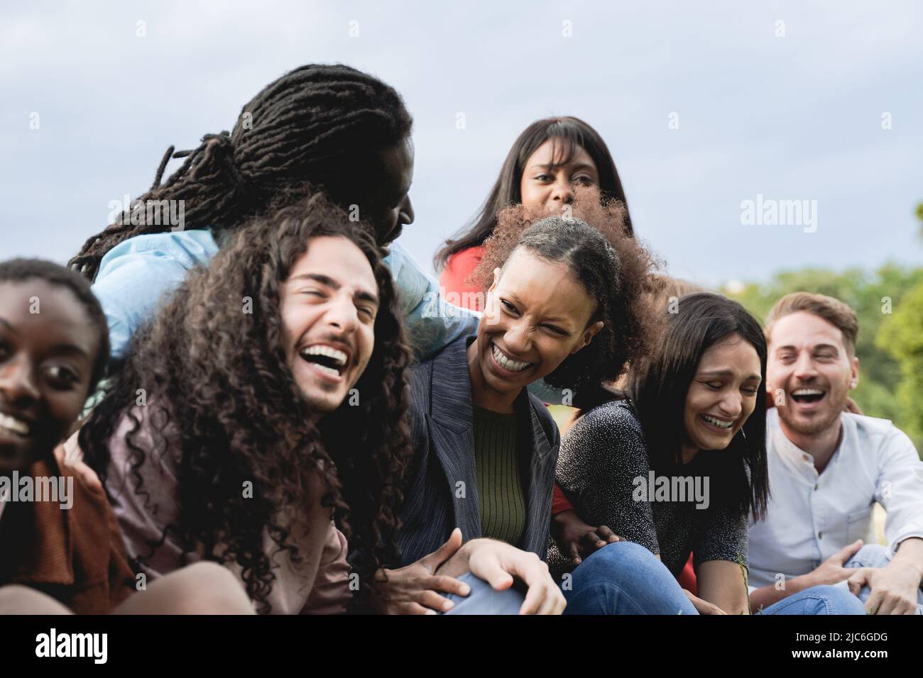 Multiethnic happy group of people having fun outdoor - Focus on center African girl face Stock Photo