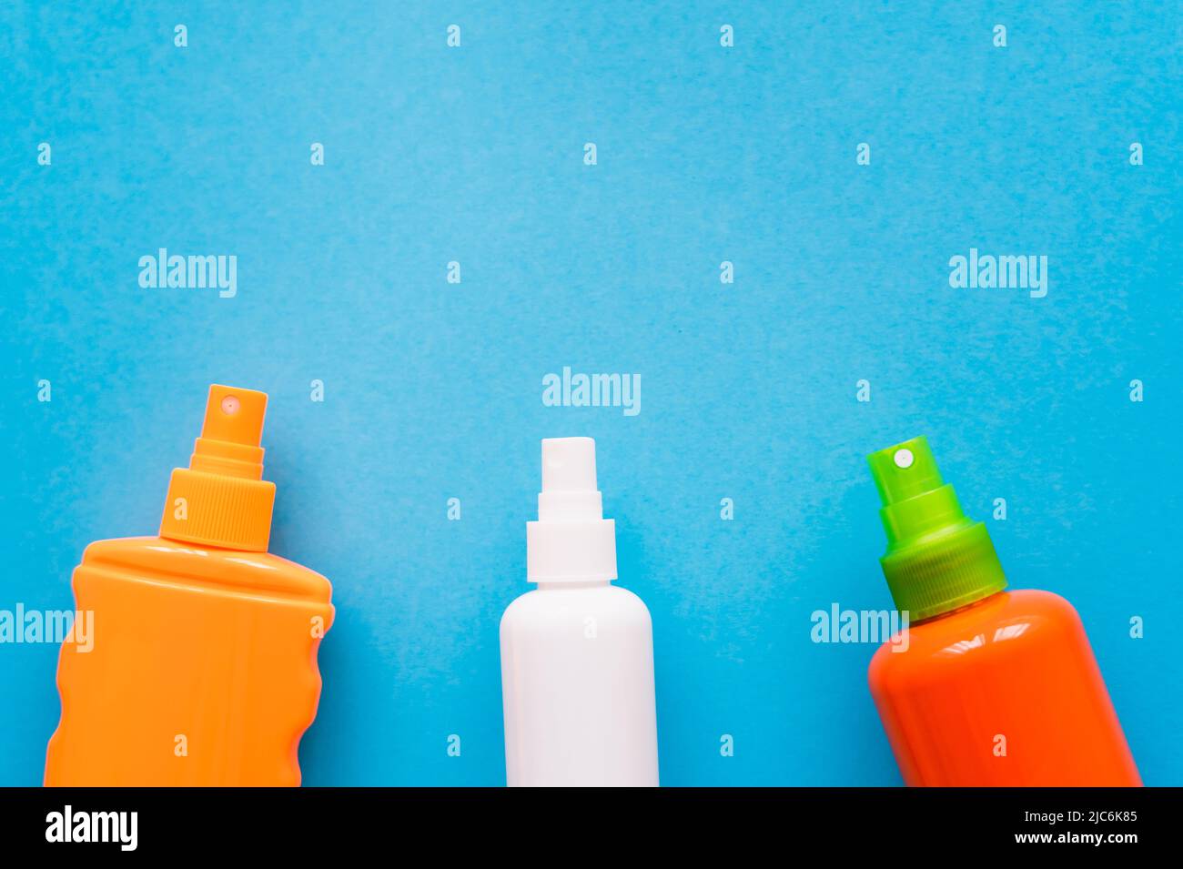 Top view of bottles of sunblock on blue background Stock Photo