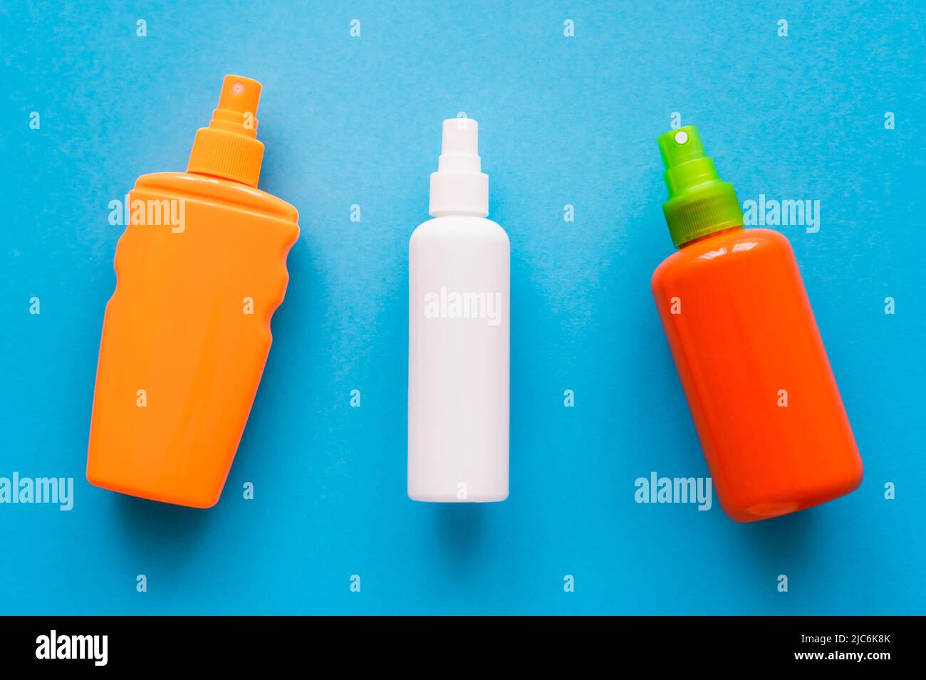 Top view of bottles of sunscreens on blue background Stock Photo