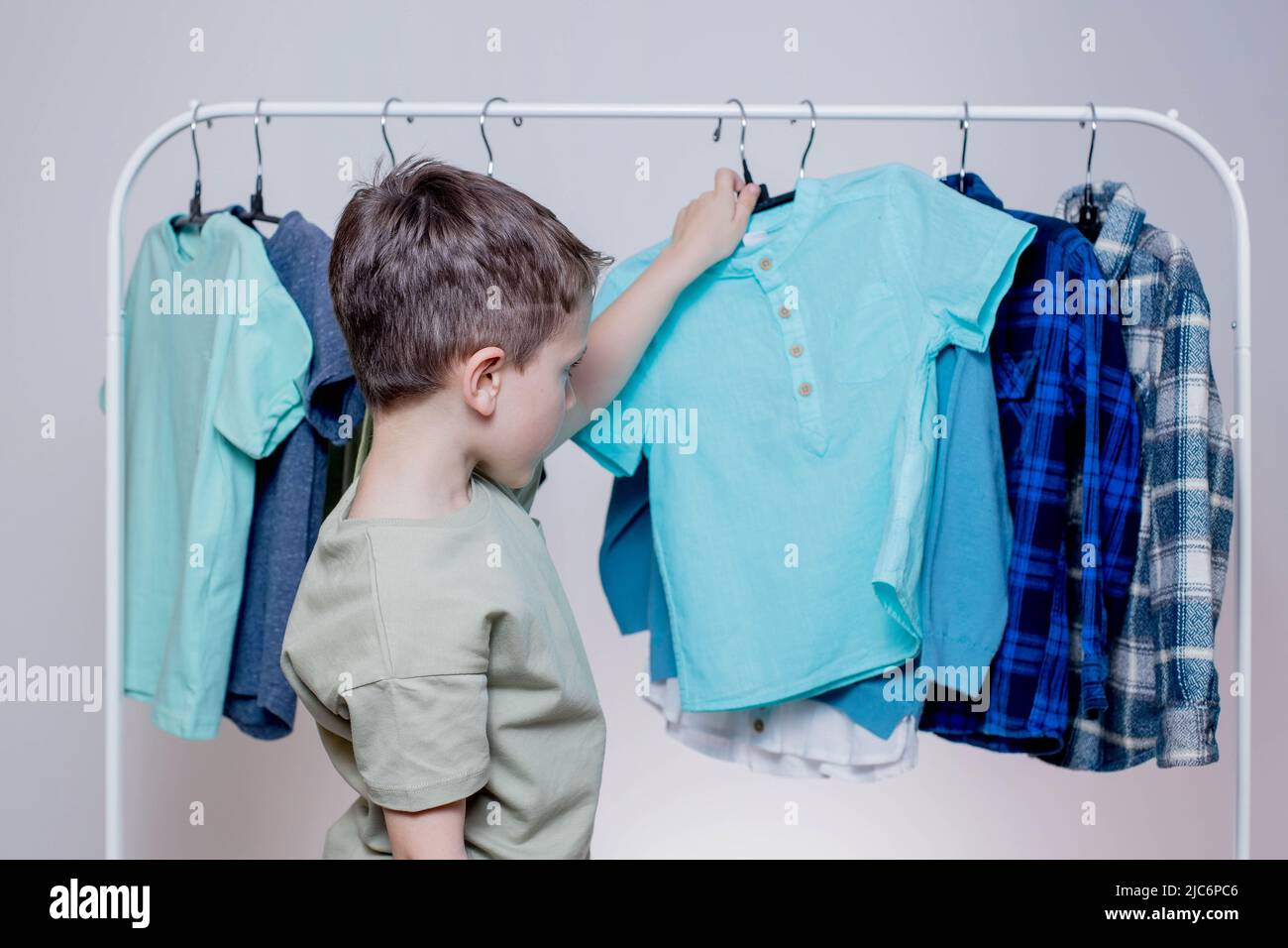 Boy preschooler standing hangers racks hi-res stock photography and ...