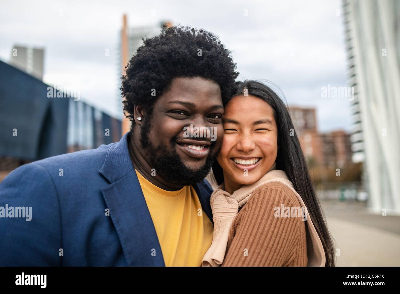 Happy young multiracial friends having fun hanging out in city Stock Photo