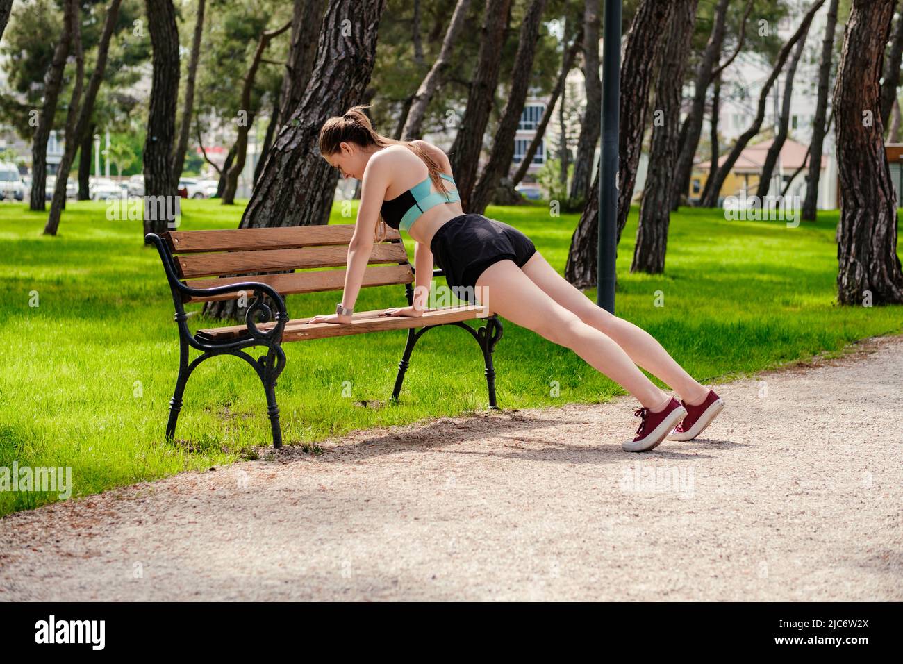 https://c8.alamy.com/comp/2JC6W2X/young-caucasian-woman-wearing-black-sports-bra-standing-on-city-park-outdoors-doing-push-ups-on-a-park-bench-healthy-lifestyle-workout-training-e-2JC6W2X.jpg