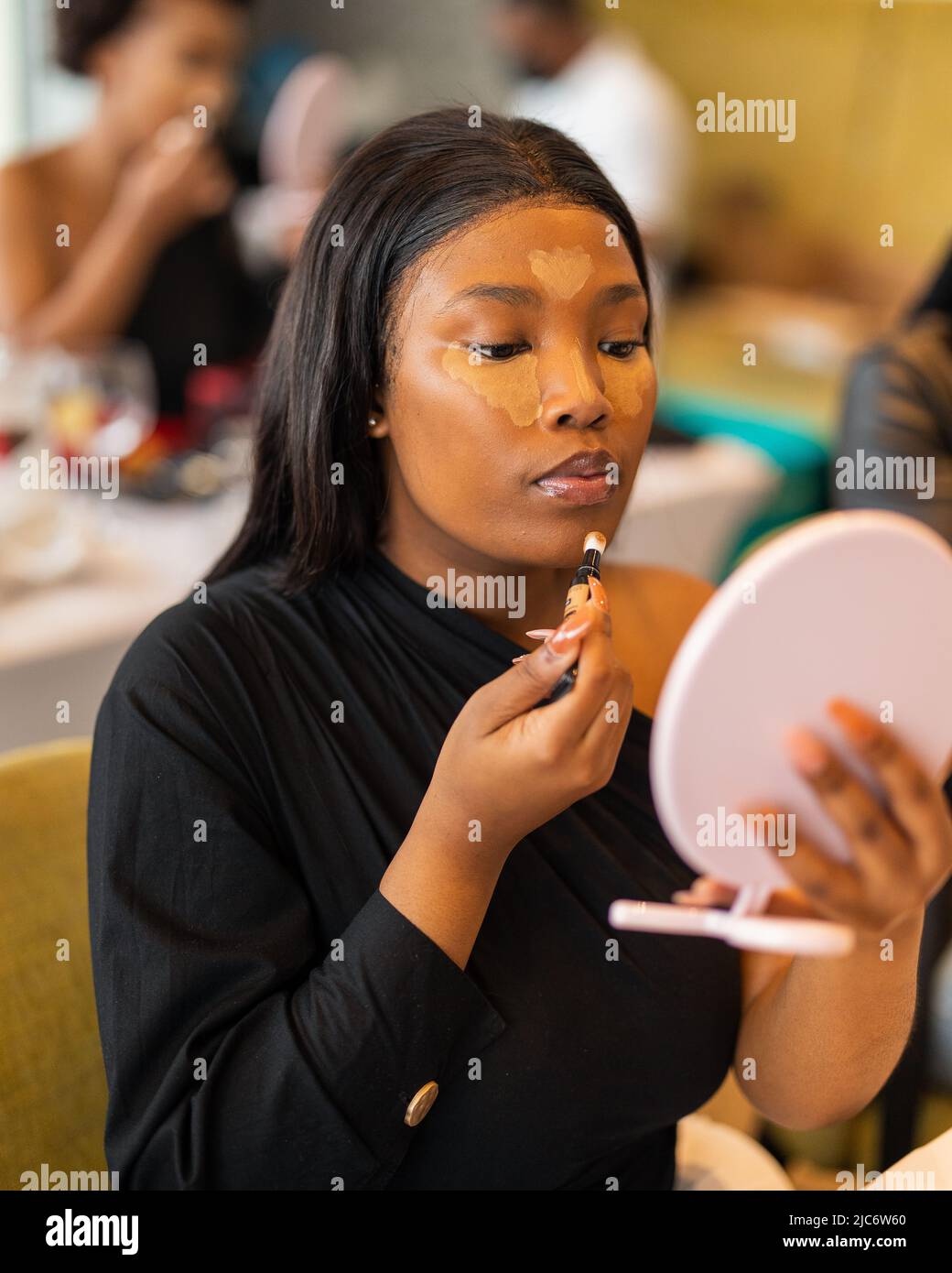 make up enthusiast photographed during a make up master class Stock
