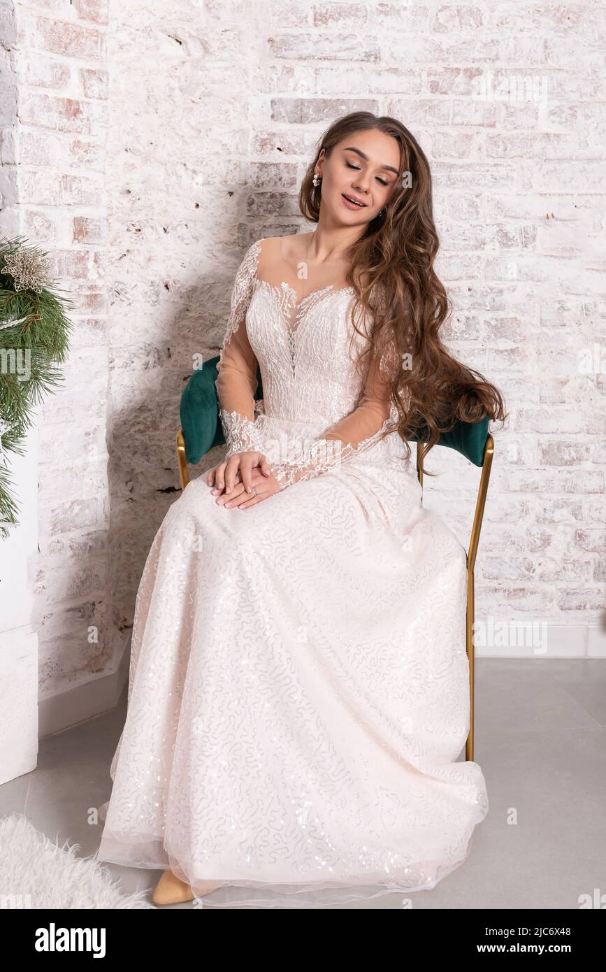 The bride in a white dress sits on a chair. High quality photo Stock ...
