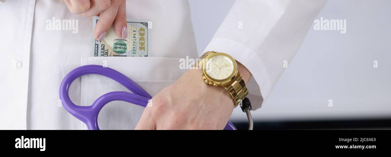Doctor carry stethoscope tool and show piece of banknote in pocket