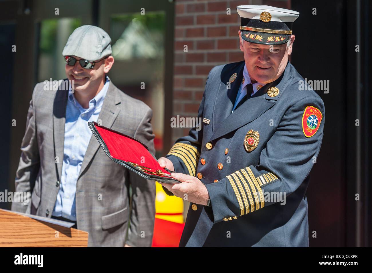 Chief Robert Hart, Acton Fire Dept, showing special scissors at ribbon