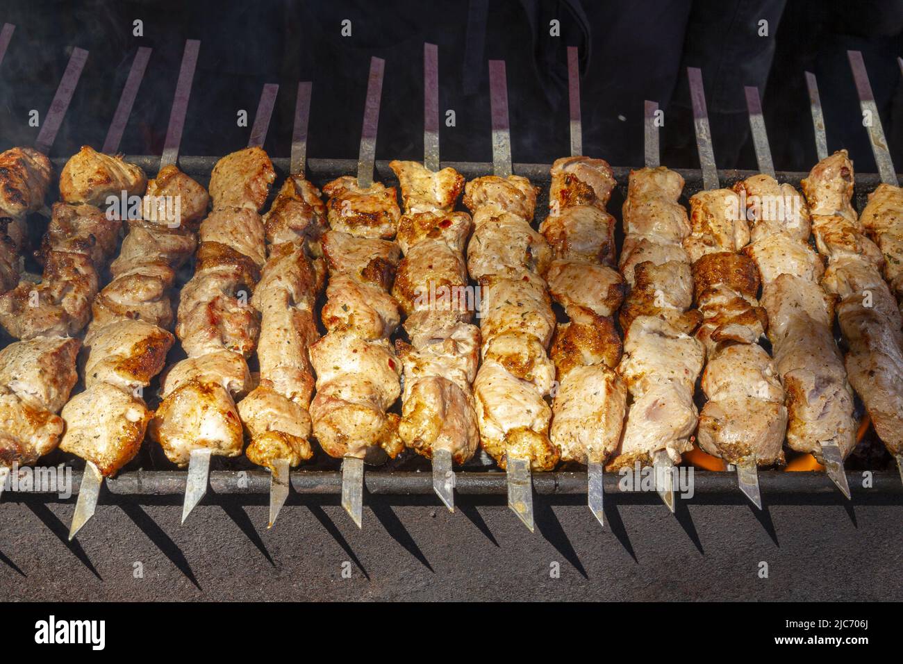 Traditional national cuisine in the form of fried meat with oriental spices on coals. Stock Photo