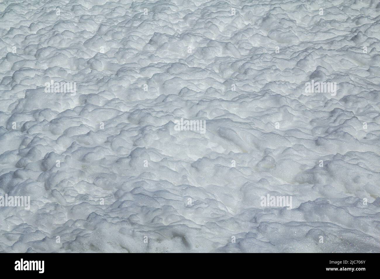 Background in the form of a large surface filled with white foam. Stock Photo