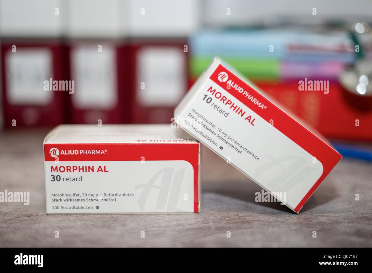 Drug box of  Morphine,pain medication of the opiate.On a table and in the background different medical books. Stock Photo