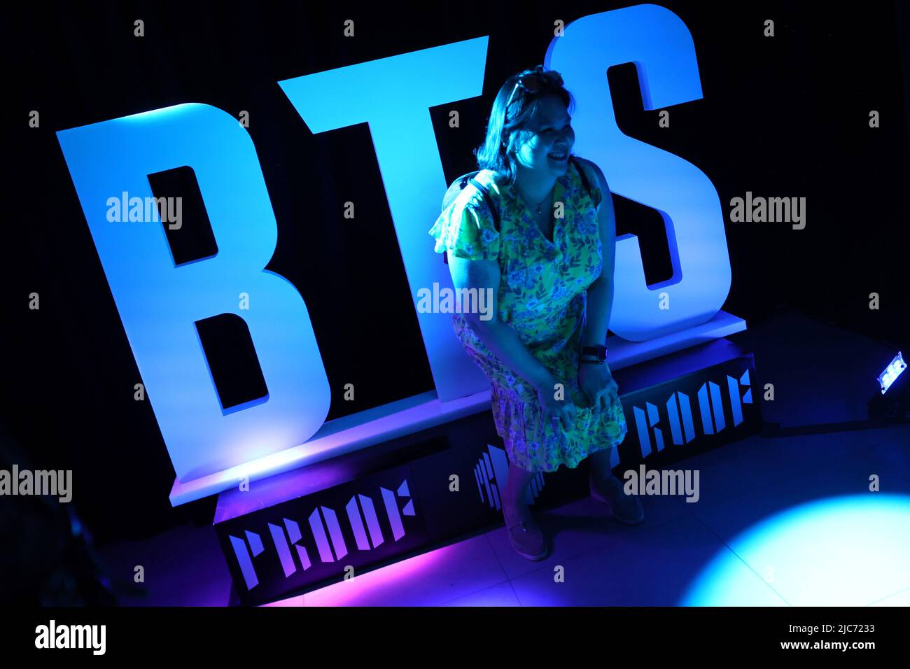 A fan of the South Korean boy band BTS poses for a picture inside a newly opened pop-up shop selling BTS merchandise after the release of their new album 'Proof' in in Manhattan in New York City, New York, U.S., June 10, 2022. REUTERS/Mike Segar Stock Photo