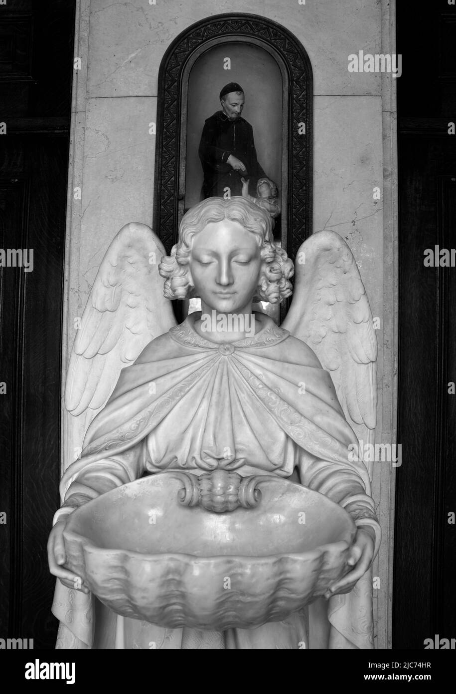 A Holy Water font in the form of an angel in Saints Peter and Paul Church in the North Beach neighborhood of San Francisco, California. Stock Photo