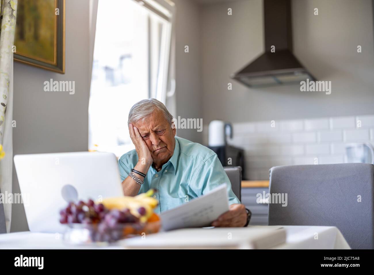 Senior man going through his financials problems Stock Photo