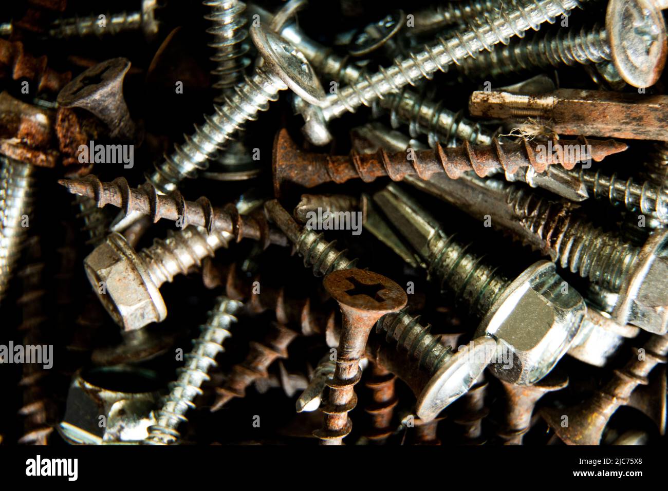 old screws and nuts and screws as background, screws and nails for background repair Stock Photo