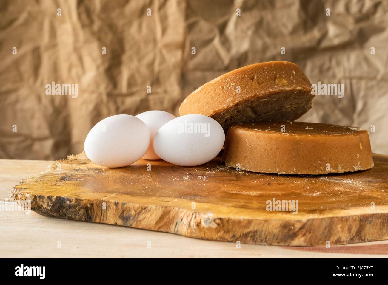 bodegon of colombian panela and eggs, placed on a wooden board of Matarraton (Gliricidia sepium), ready for sale or human consumption. ingredients for Stock Photo