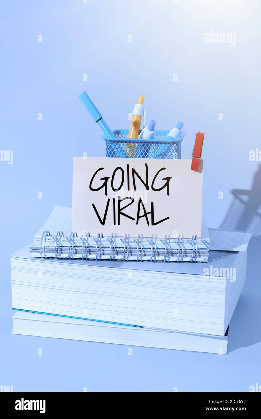 Hand writing sign Going Viral. Business concept image video or link