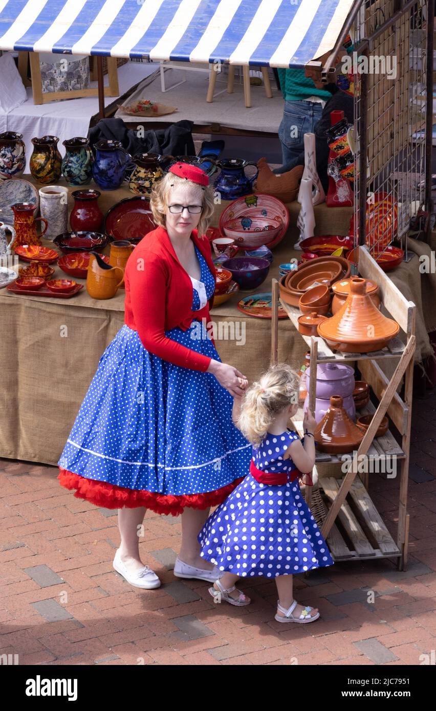 Unusual UK lifestyle; a mother and daughter dressed in casual 1950s style clothes fashion, shopping in the market, present day, Ely Cambridgeshire UK Stock Photo