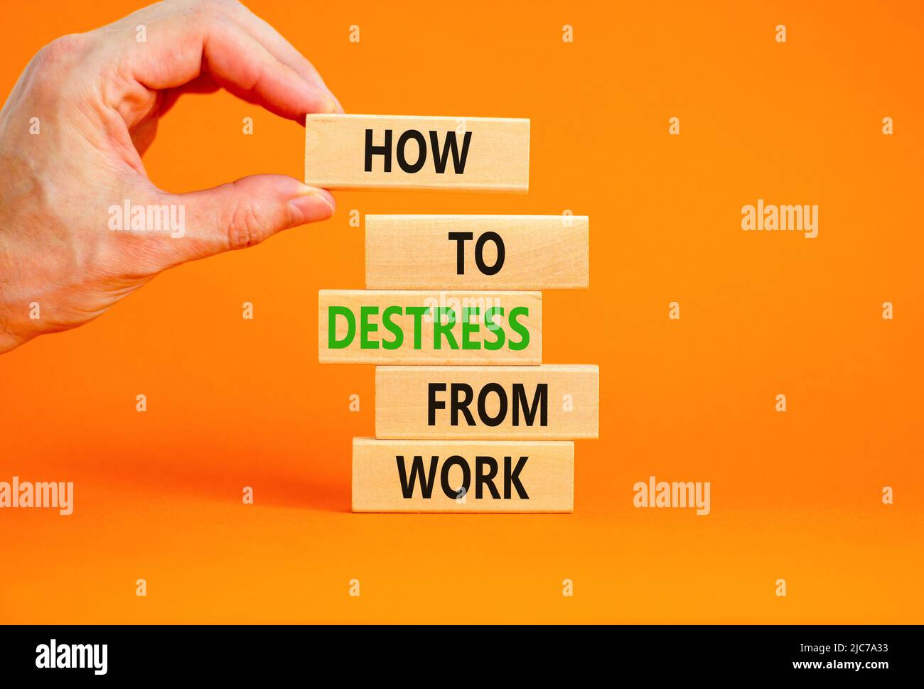 Destress from work symbol. Concept words How to destress from work on wooden blocks. Doctor hand. Beautiful orange background. Psychological business Stock Photo
