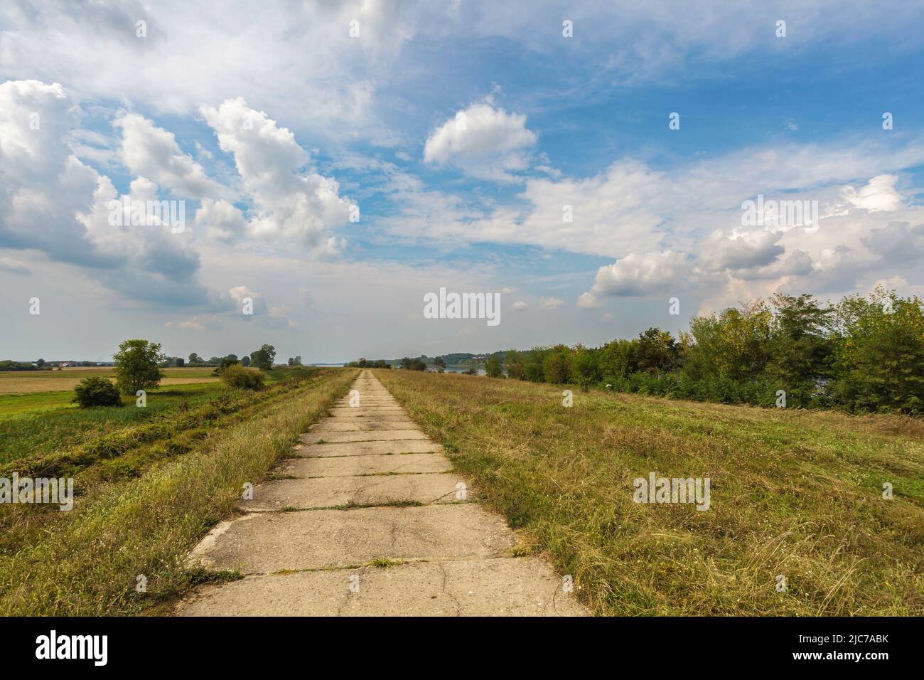 Old concrete way under blue cloudy sky Stock Photo