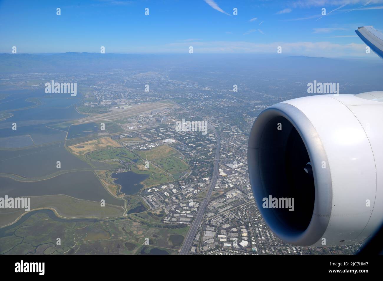 A Swiss Boeing 777-300ER (LX38) turning onto finals for SFO airport over Moffett Field, Silicon Valley CA Stock Photo