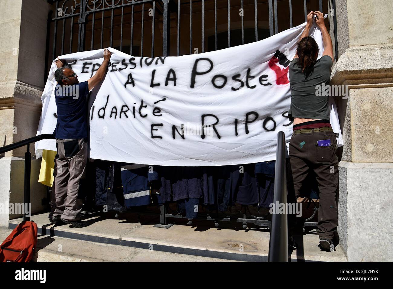 Marseille, France. 09th June, 2022. Protesters hang a banner at the gate during the demonstration. The Marseille postal workers held a strike against the reorganisation of rounds in the 1st, 2nd, 3rd, 4th and 14th arrondissements of Marseille which would lead to job cuts. (Photo by Gerard Bottino/SOPA Images/Sipa USA) Credit: Sipa USA/Alamy Live News Stock Photo