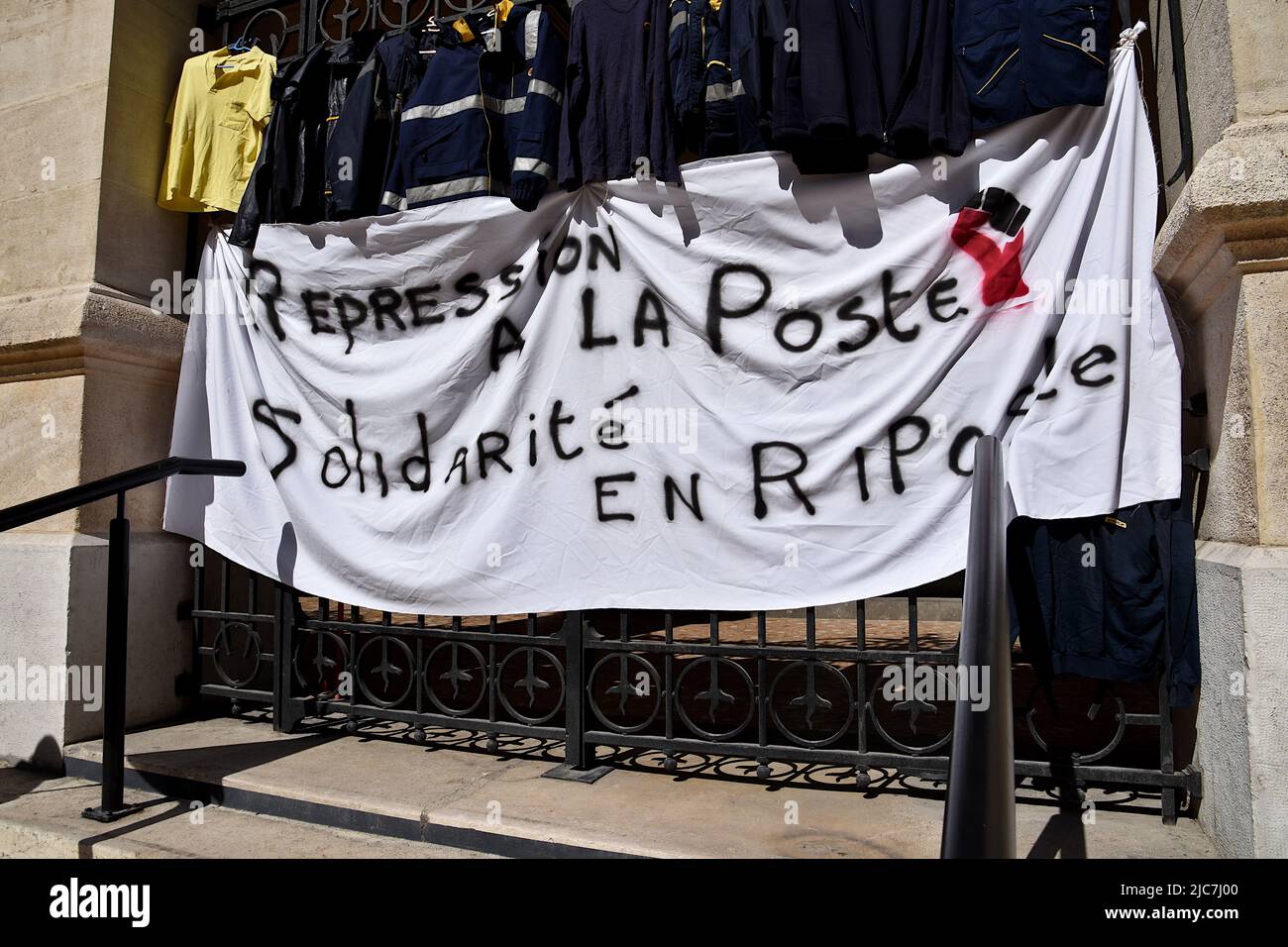 Marseille, France. 09th June, 2022. A banner and work jackets seen hanging at the gate during the protest. The Marseille postal workers held a strike against the reorganisation of rounds in the 1st, 2nd, 3rd, 4th and 14th arrondissements of Marseille which would lead to job cuts. (Photo by Gerard Bottino/SOPA Images/Sipa USA) Credit: Sipa USA/Alamy Live News Stock Photo