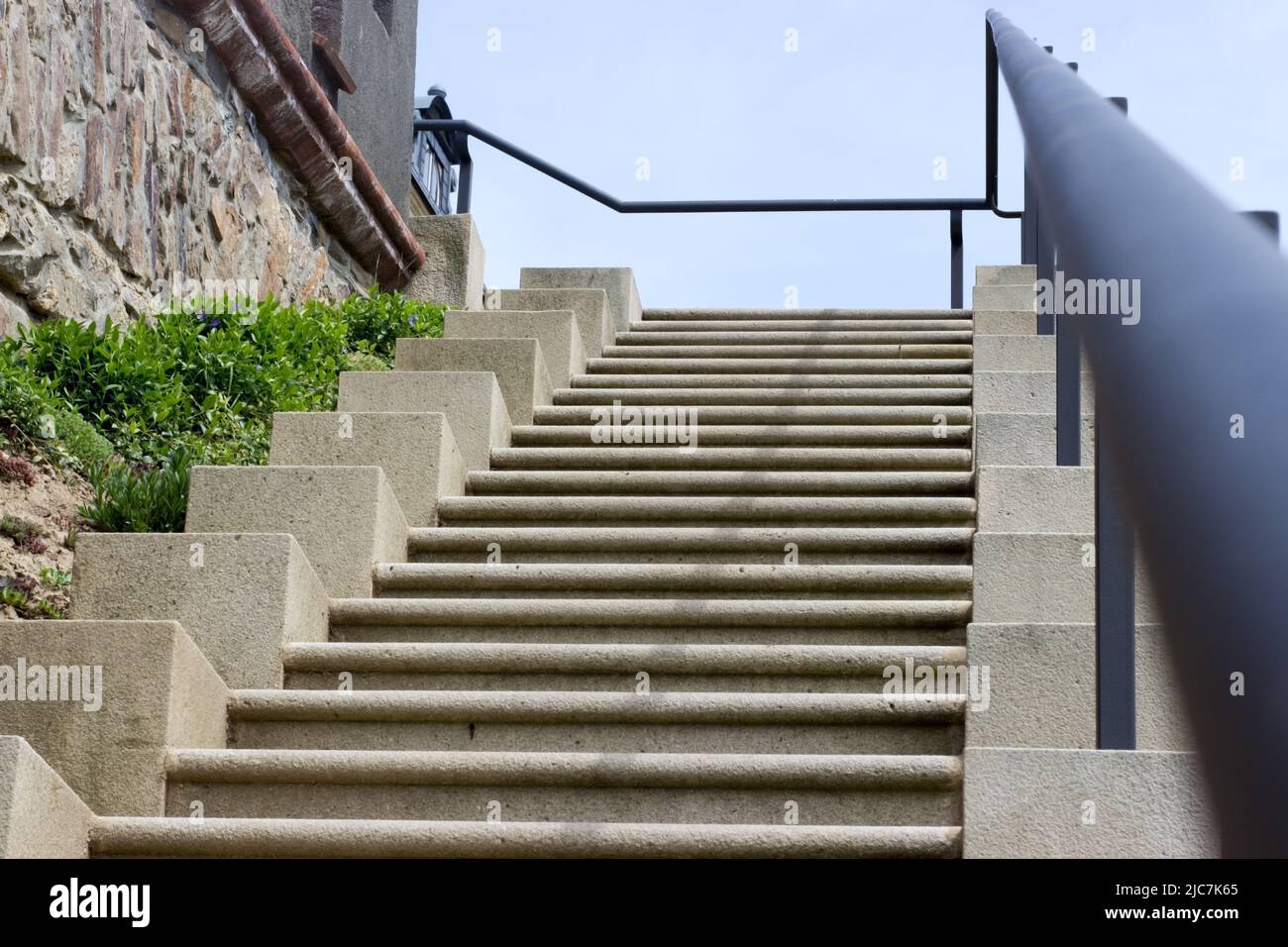 concrete stairs with iron railings, stone wall Stock Photo