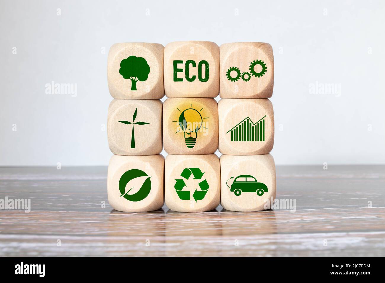 Carbon ecological footprint symbols on wooden cube with eco friendly icon. Stock Photo