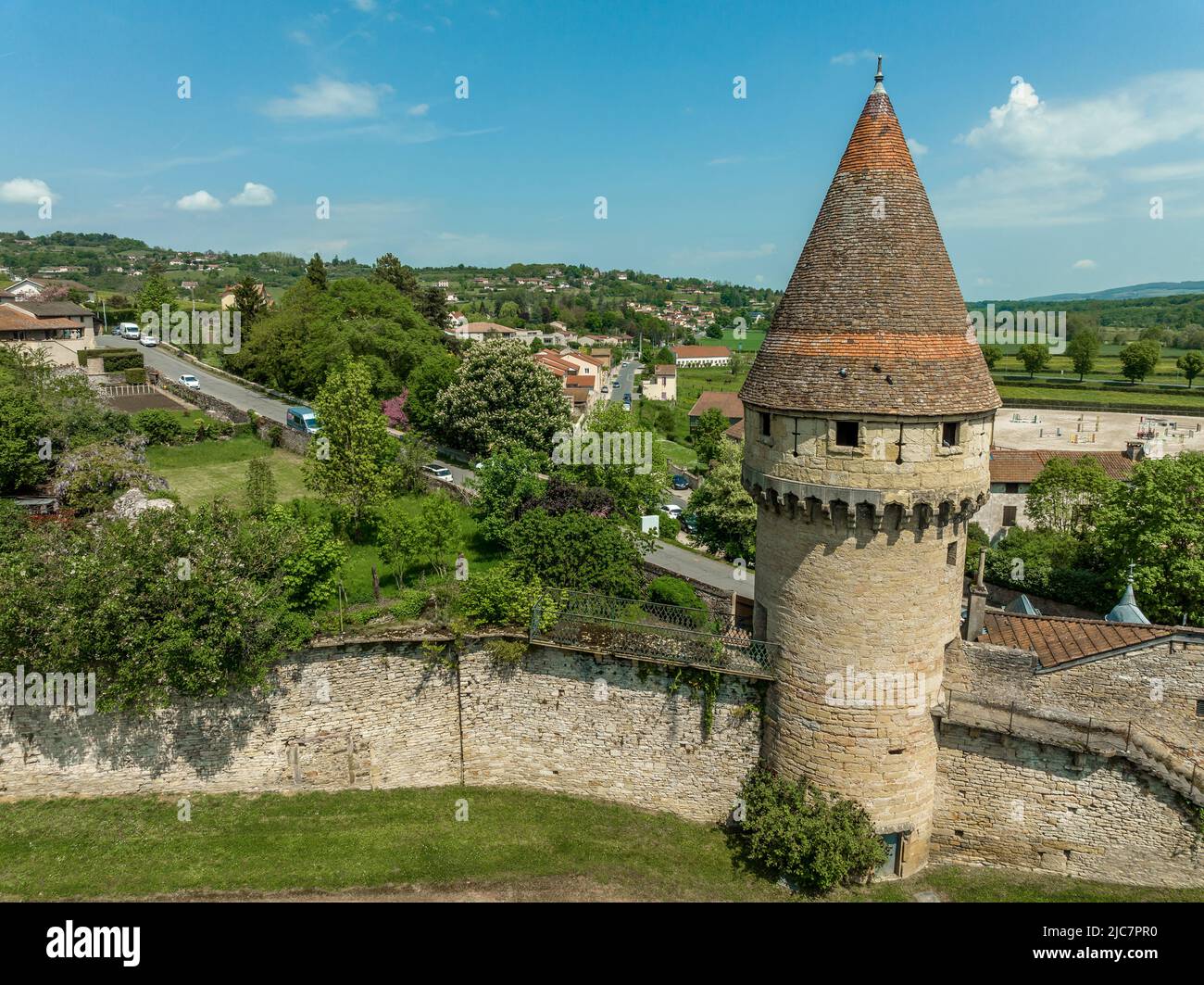 Circular defensive tower with loopholes piercing the town walls of