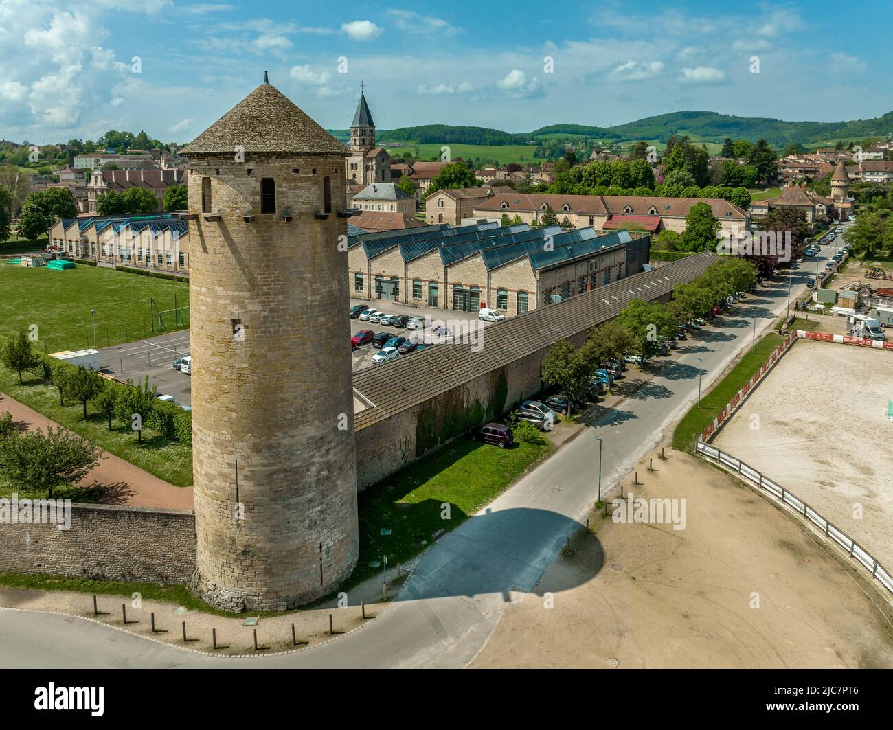 Circular defensive tower with loopholes piercing the town walls of