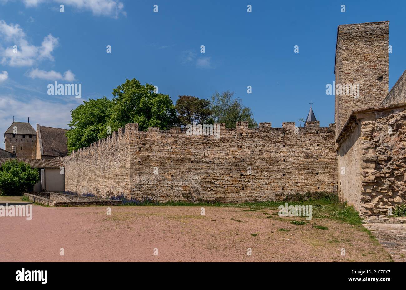 Rectangular defensive tower with loopholes piercing the town walls of