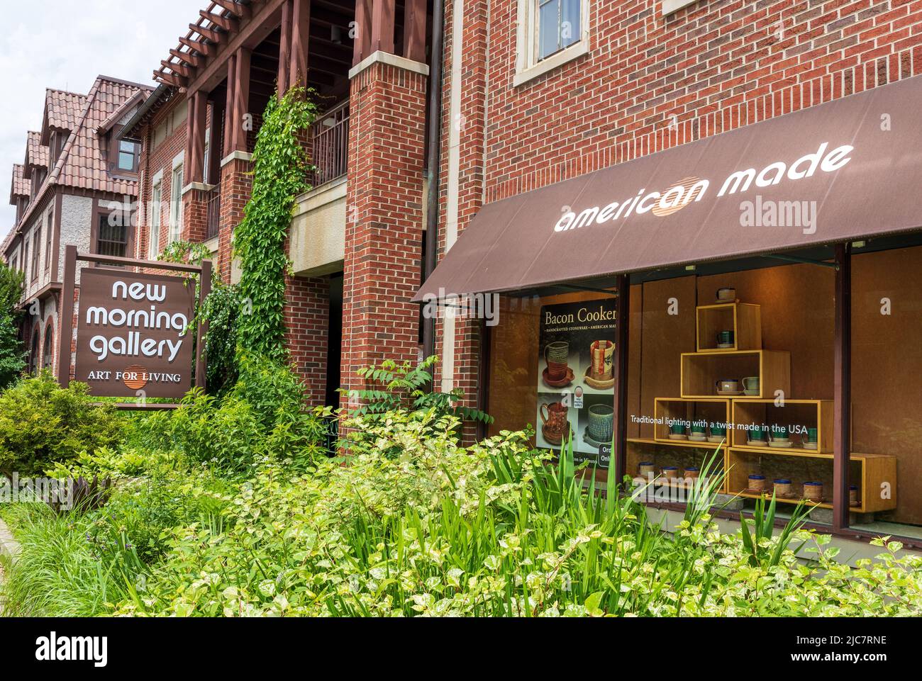 BILTMORE VILLAGE in ASHEVILLE, NC, USA-5 JUNE 2022: New Morning Gallery. Display window and monument sign.  Horizontal image Stock Photo